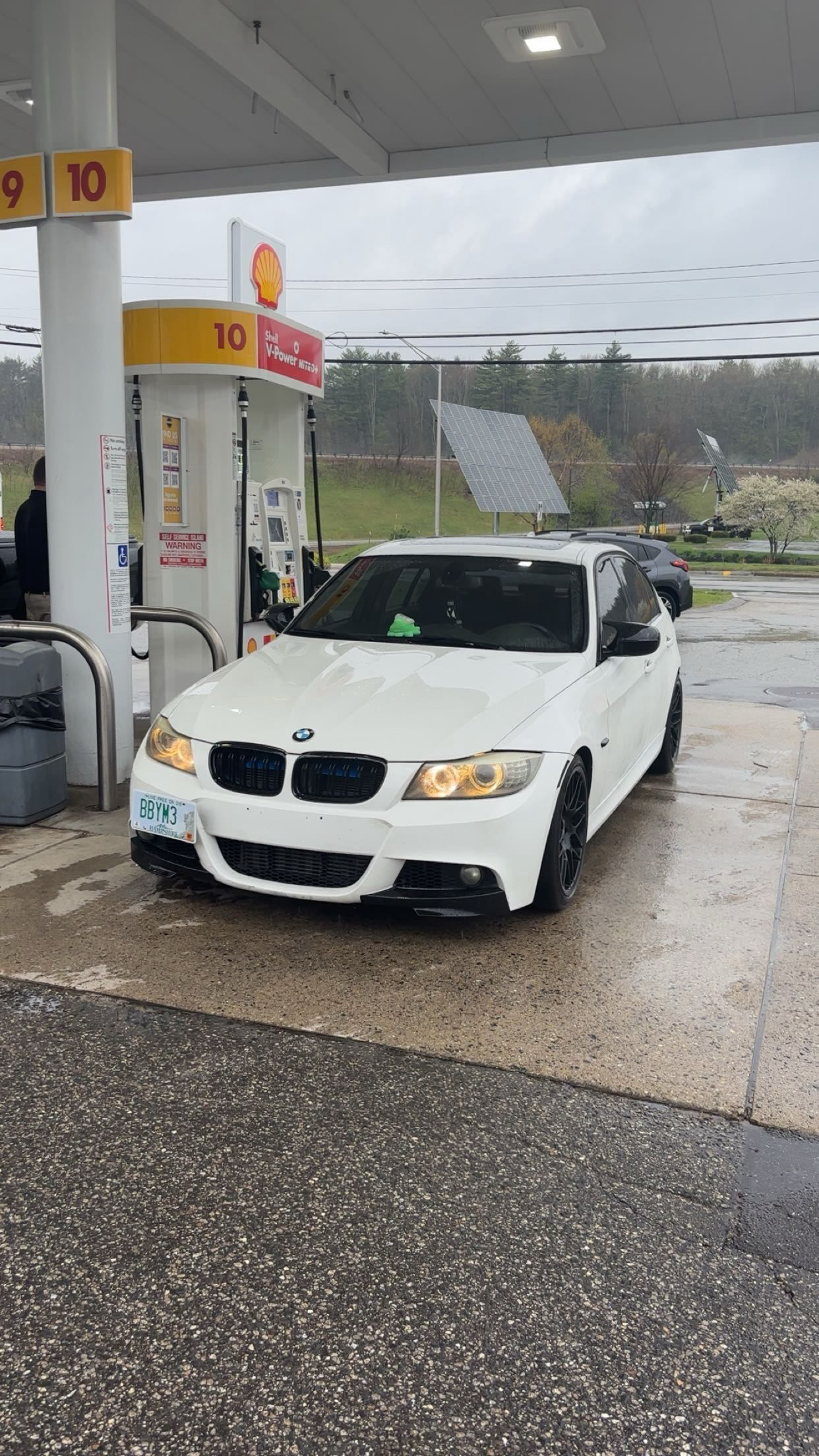 Mason's white 2011 BMW 335i E90 parked at a gas station